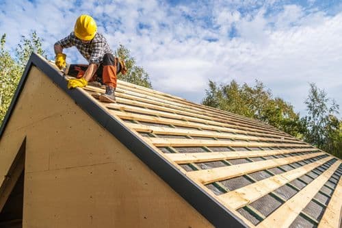 Roof repair worker on Fort Worth residential roof